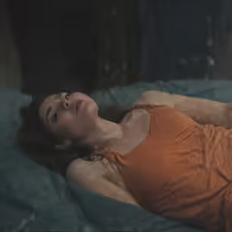 a woman laying down on her side sleeping