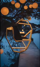 some lights hanging from a tree over a body of water