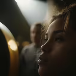 a woman looks up with her nose covered