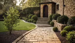 a home with stone steps and landscaping surrounding