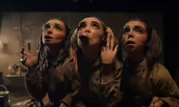 three women are in the kitchen with their mouths open