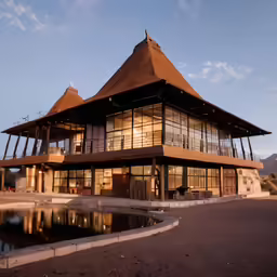 a building with several levels that has a water fountain in front of it