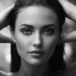 a beautiful young lady holding her hair up