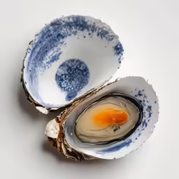 two blue and white bowls have an egg inside