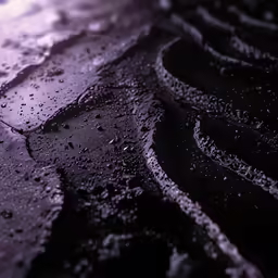 water running down a street with a large tire cover