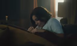 a woman laying her head on her hand