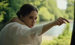 the girl is trying to stop the traffic on the train