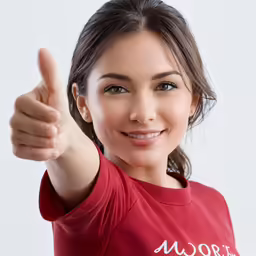 a smiling woman giving a thumbs up sign