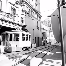 a trolley car traveling down the middle of a street