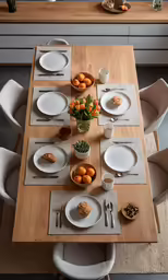 a dinner table is set with white plates