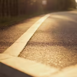 the sun shining on a street with no cars
