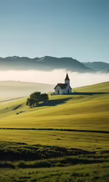 the church sits on top of a grassy hill