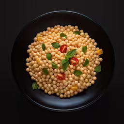 a plate of raw food with chickpeas and vegetables