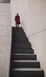 a man in a red coat walks up a set of stairs