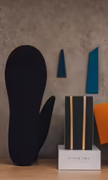 a book shelf with art on it with a design on top