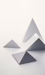 three silver triangles in three different shapes