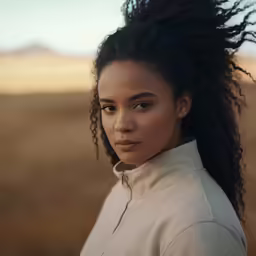 woman with large black dreadlocks in the desert