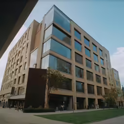 an office building with large windows and lots of plants