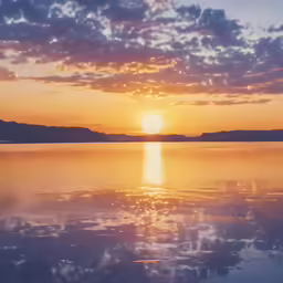 a sun setting over the ocean with water reflecting it