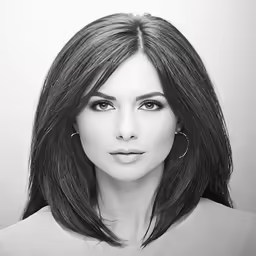 an attractive black and white woman with bangs