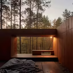 an outdoor room has a wooden wall and a wood floor