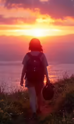 a person walks towards the sunset with a backpack