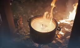 a candle burning in front of a fire pit