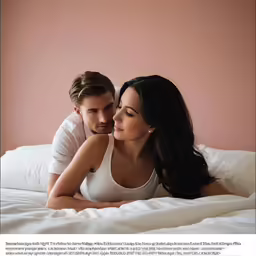 a man and woman are on a white blanket