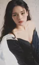 the woman is posing on the white wall