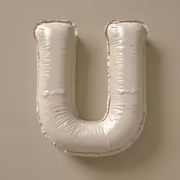 a white metal wall hanging shaped like the letter u