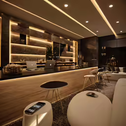 a room with an illuminated bar, chairs and tables