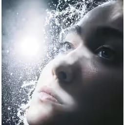 a woman staring at the water in her eyes