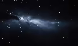 night sky with light shining in the clouds and stars