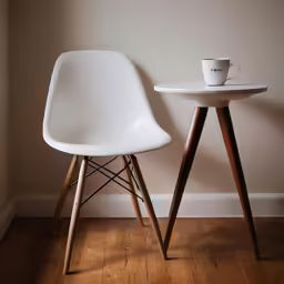 a wooden table and chair next to the wall