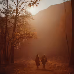 two women walking down the side of a trail