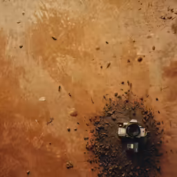 a photo of a camera sitting on top of dirt