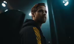 a man with a beard looking up to the right