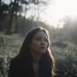 there is a woman standing in a field