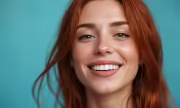 a redheaded woman smiles into the camera