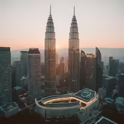 the top of two large buildings at dusk