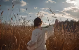there is a woman standing in the tall grass