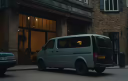 the van is parked next to the building in the city