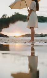 a girl standing in water and holding an umbrella