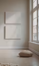 the small pillow is near a square blank piece