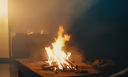 an open fire on top of a wooden table