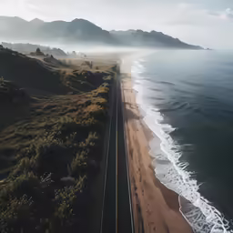 a train that is on the tracks by the ocean