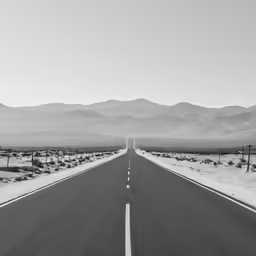 a long empty street sits in the middle of nowhere