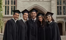 a group of people with caps and gowns posing for a photo