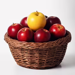 a basket holding several red and yellow apples