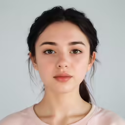 a woman with a round face looks into the camera